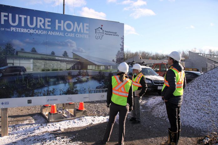 kawarthaNOW publisher Jeannine Taylor and writer Paul Rellinger were invited to a private onsite tour of the Peterborough Humane Society's existing location, which opened in 1956, and the new Peterborough Animal Care Centre, currently under construction and slated to open fall 2022. Pictured at the construction site are (left to right), Peterborough Humane Society corporate partnerships and marketing manager Julie Howe, Paul Rellinger, and Peterborough Humane Society executive director Shawn Morey. (Photo: Jeannine Taylor / kawarthaNOW)