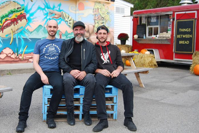 Olympus Burger owner Giorgos Kallonakis (left) offered to rent his unused food truck to Rikki Mckenzie, Shayne Traviss, and Eric Ashley-Harris (not pictured) for their new food venture. (Photo: April Potter / kawarthaNOW)