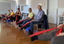 Instructor Jenn Stubbert (third from left) leads participants in a "Minds in Motion" class offered by the Alzheimer Society of Peterborough, Kawartha Lake, Northumberland, and Haliburton. The program provides people living with early to mid-stage dementia and their care partners with gentle and easy-to-follow physical activities followed by fun social activities. The program runs online for one hour weekly and in person for two hours weekly. (Photo courtesy of the Alzheimer Society)