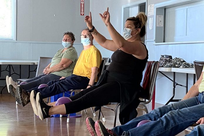 Jenn Stubbert (third from left) leads participants during an in-person Minds in Motion session. During the first hour of the class, participants engage in fun physical exercise. In the second hour, they enjoy refreshments and participate in social activities. (Photo courtesy of the Alzheimer Society)