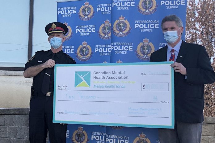 Mark Graham, CEO of the Canadian Mental Health Association Haliburton, Kawartha, Pine Ridge, accepts a $10,000 donation from the Peterborough Police Services Board Auction Fund that will support a new mobile mental health and addictions clinic for the greater Kawarthas region launching in 2022. (Photo courtesy of CMHA HKPR)