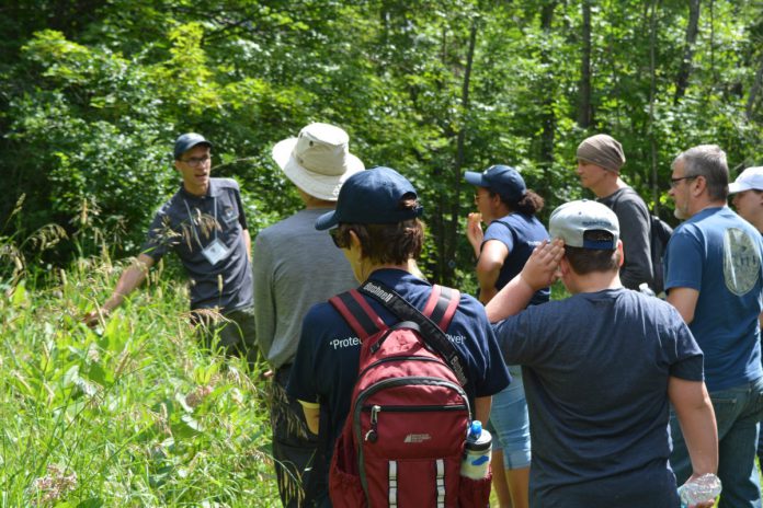 Thom Unrau (left), Land Stewardship Manager with Kawartha Land Trust, leads a 2016 hike on Stony Lake Trails in North Kawartha Township. The 10-kilometre trail network was made possible with the support of donors, volunteers, and neighbouring landowners who have assisted with locating the property's old unmanaged trails, fixing the trails up, and contributing to their long-term maintenance. Many landowners have also provided permission for the trail network to cross over their private lands. (Photo courtesy of Kawartha Land Trust)