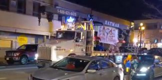 A flatbed truck travels down George Street in Peterborough as part of an illegal parade on December 11, 2021. (Screenshot of Twitter video)