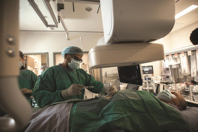 Dr. Fady Abdelsayed demonstrates an interventional radiology procedure at Peterborough Regional Health Centre. The minimally invasive alternative to conventional surgery uses real-time imaging to steer needles, guidewires, and catheters into tiny incisions in the skin or through blood vessels to perform a procedure. Because it's minimally invasive, patients have less pain, shorter hospital stays, and face fewer risks than with traditional surgery. (Photo: Michael Hurcomb)