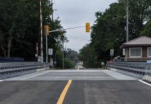 The perforated steel plates located on the outer edge of both traffic lanes on Warsaw Road swing bridge on Parkill Road in Peterborough, intended to provide a smooth and safe ride over the bridge for cyclists, are being removed until the spring due to elevanted notice levels when vehicles travel over the bridge. (Photo: Bruce Head / kawarthaNOW)