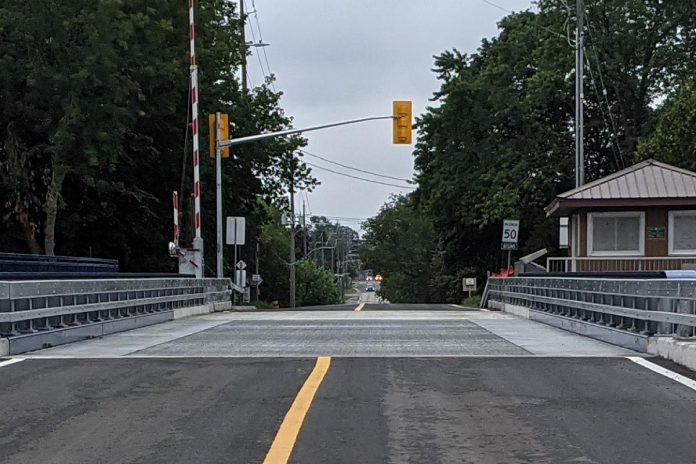 The perforated steel plates located on the outer edge of both traffic lanes on Warsaw Road swing bridge on Parkill Road in Peterborough, intended to provide a smooth and safe ride over the bridge for cyclists, are being removed until the spring due to elevanted notice levels when vehicles travel over the bridge. (Photo: Bruce Head / kawarthaNOW)