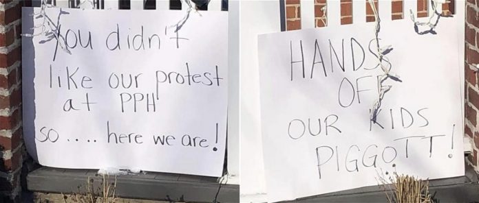 Protest signs that appears to have been placed on Dr. Piggott's property. (Photos from private Facebook group supplied to kawarthaNOW)