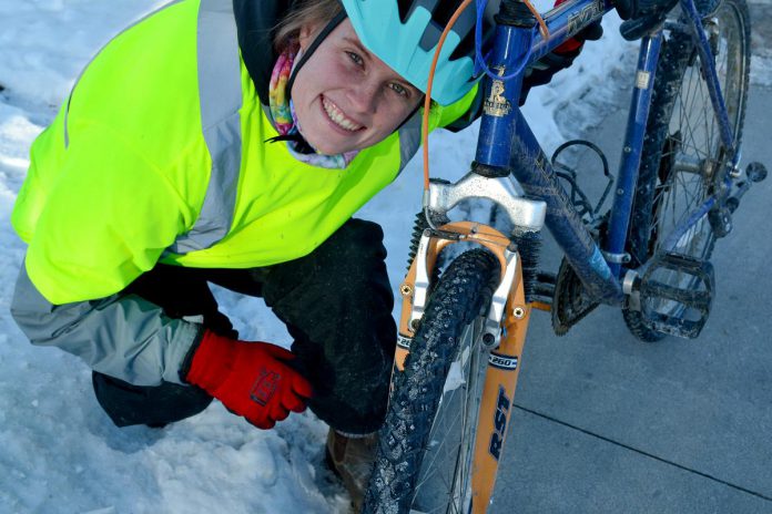 Winter Wheels participant Cara Livingston shows off the studded tires on her bicycle. As part of its Winter Wheels program, B!KE: The Community Bike Shop provides a free set of studded tires to ensure new winter riders have a safe and positive experience. (Photo: Jacob Bozek)