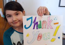 Young Peterborough resident Meara holds artwork she created to thank local medical officer of health Dr. Thomas Piggott, which her mother posted in the new 'Nogojiwanong Peterborough Stands With Dr Piggott' Facebook group. The group is intended for Peterborough residents to show their support for Dr. Piggott after two recent incidents where anti-vaxxers visited his personal residence, where he lives with his wife and their two young daughters.