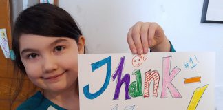 Young Peterborough resident Meara holds artwork she created to thank local medical officer of health Dr. Thomas Piggott, which her mother posted in the new 'Nogojiwanong Peterborough Stands With Dr Piggott' Facebook group. The group is intended for Peterborough residents to show their support for Dr. Piggott after two recent incidents where anti-vaxxers visited his personal residence, where he lives with his wife and their two young daughters.