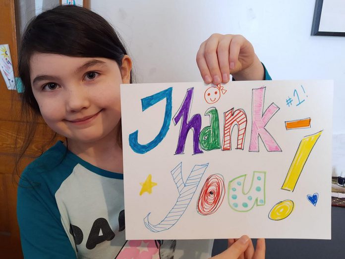 Young Peterborough resident Meara holds artwork she created to thank local medical officer of health Dr. Thomas Piggott, which her mother posted in the new 'Nogojiwanong Peterborough Stands With Dr Piggott' Facebook group. The group is intended for Peterborough residents to show their support for Dr. Piggott after two recent incidents where anti-vaxxers visited his personal residence, where he lives with his wife and their two young daughters.