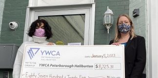 Christine Teixeira (right), president of the Women's Business Network of Peterborough, presents a cheque for $8,725.31 to Ria Nicholson, lead philanthropic advisor with YWCA Peterborough Haliburton. The funds, raised in December 2021 during the networking organization's annual holiday gala, will support the YWCA Crossroads Shelter for women and children fleeing violence and abuse. (Photo: Yvonne Porter)