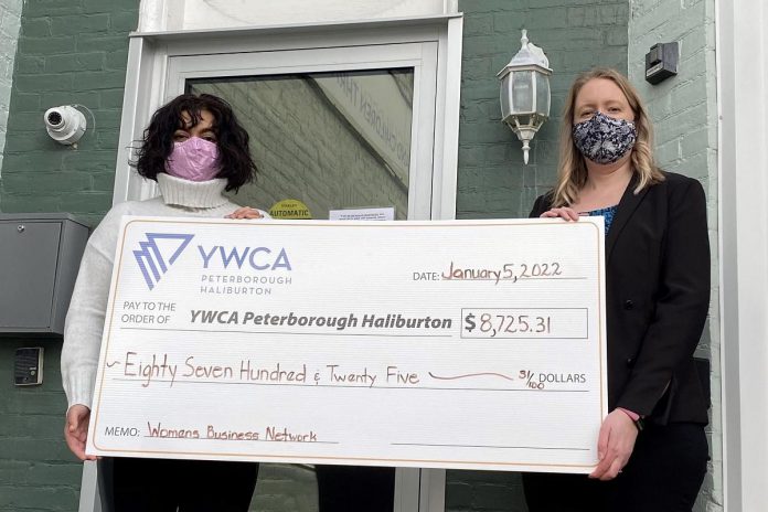 Christine Teixeira (right), president of the Women's Business Network of Peterborough, presents a cheque for $8,725.31 to Ria Nicholson, lead philanthropic advisor with YWCA Peterborough Haliburton. The funds, raised in December 2021 during the networking organization's annual holiday gala, will support the YWCA Crossroads Shelter for women and children fleeing violence and abuse. (Photo: Yvonne Porter)