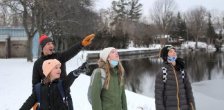 A family walking to school along the Trent-Severn Waterway spots a large bird in a nearby tree. Is it a hawk, an eagle, or an owl? These aerial predators are common sights at this time of year and can make for exciting wildlife sightings during a winter walk to school. (Photo: Genevieve Ramage for GreenUP)