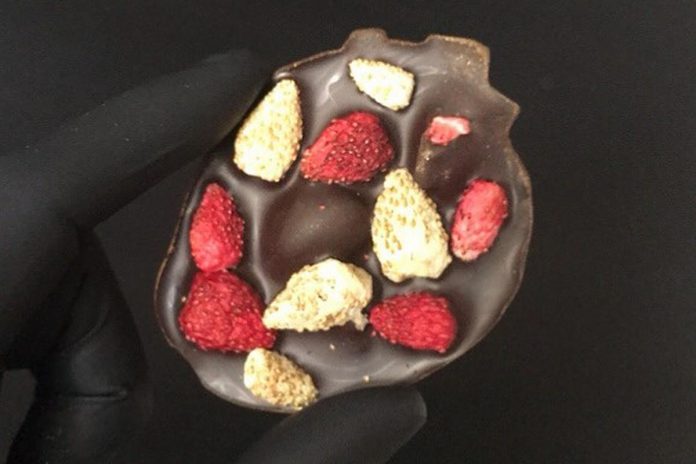 The centrepiece of Centre & Main Chocolate Co.'s Love Box, which contains four chocolate bars that include locally grown ingredients, is an anatomical chocoklate heart dusted in gold and studded with locally grown alpine strawberries. (Photo: Centre & Main Chocolate Co.)