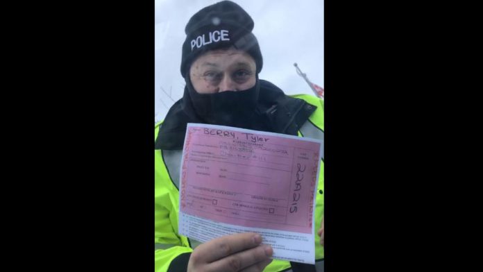 Local anti-lockdown and anti-vaccine mandate advocate Tyler Berry refused to roll down his vehicle window after Peterborough police pulled him over and showed him an arrest warrant  on February 26, 2022. (kawarthaNOW screenshot of Facebook video)