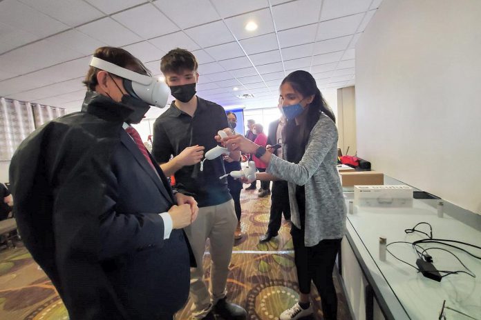 During a media event in Peterborough on February 25, 2022, Ontario minister for seniors and accessibility Raymond Cho (left) tries out the Council for Persons with Disabilities' virtual reality component of the organization's Time in My Shoes experiential program that emulates what it is like to have a disability. (Photo: Ontario Ministry for Seniors and Accessibility)