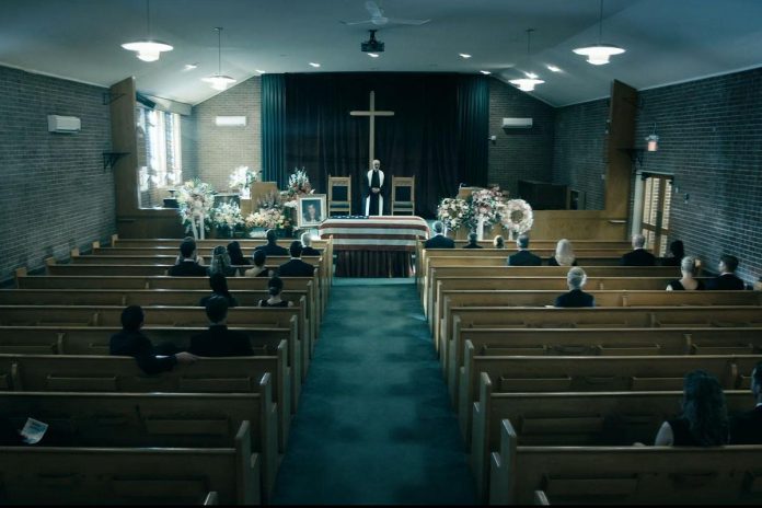 Wyatt Lamoureux also appeared as a minister in this wide shot of a funeral scene from an episode of "The Boys". (kawarthaNOW screenshot)