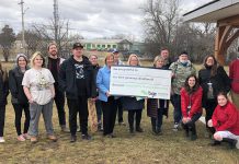 Haliburton-Kawartha Lakes-Brock MPP Laurie Scott and BGC Kawarthas board president Catherine Miller and executive director Amy Terrill hold a message of gratitude while surrounded by BGC Kawarthas staff, youth members, and special guests during an announcement on March 25, 2022 of a $475,000 Ontario Trillium Foundation grant to help construct a community skatepark. (Photo courtesy of BGC Kawarthas)
