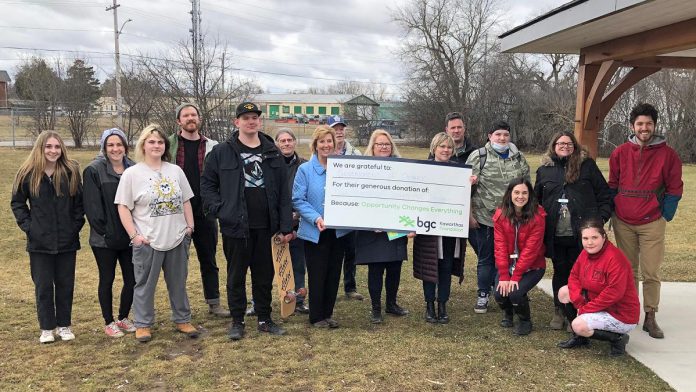 Haliburton-Kawartha Lakes-Brock MPP Laurie Scott and BGC Kawarthas board president Catherine Miller and executive director Amy Terrill hold a message of gratitude while surrounded by BGC Kawarthas staff, youth members, and special guests during an announcement on March 25, 2022 of a $475,000 Ontario Trillium Foundation grant to help construct a community skatepark. (Photo courtesy of BGC Kawarthas)