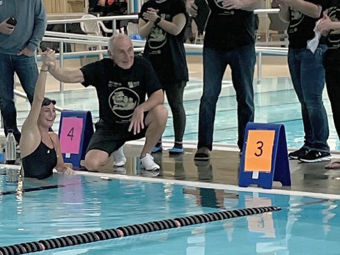 Carl Oake, who founded the Carl Oake Rotary Swim in 1987, congratulating his daughter Renee Oake after she completed 156 lengths at the 36th annual swim on February 25, 2022, which has raised over $50,000 in support of the Rotary Club of Peterborough projects and Easter Seals. (Photo: Rotary Club of Peterborough / Facebook)