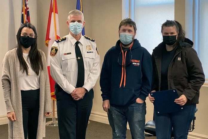 Laura Blake, Shawn Torrison, and Hilary Caird (pictured with Cobourg police chief Paul VandeGraaf) worked together to pull a woman from Lake Ontario on Boxing Day. (Photo: Cobourg Police Service)
