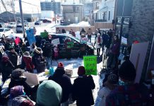 Malaika Collette, playing the role of the federal minister of environment and climate change, discusses the environmental effects of climate change during a mock press conference outside of MP Michelle Ferreri's office in Peterborough on March 12, 2022. The event was one of 50 "Day of Action for a Just Transition" events organized across Canada by 350.org and The Council of Canadians. (Photo: Tricia Clarkson)