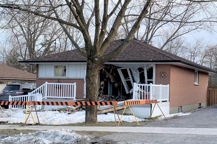 Police closed the area while the car was removed from the house, which was extensively damaged.  (Photo: Brian Papypra)