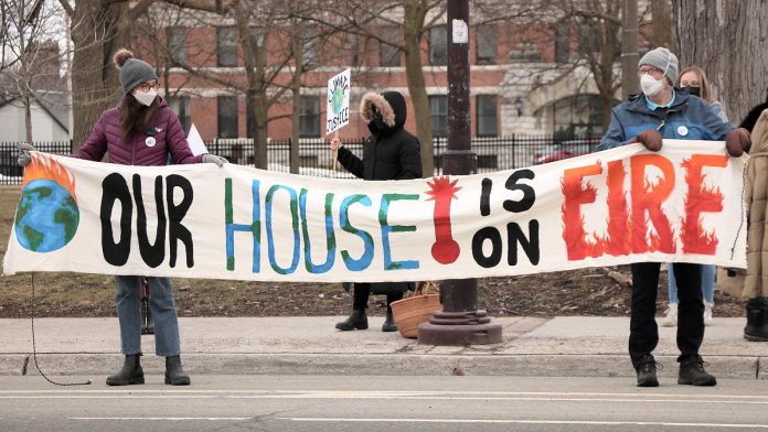 Climate activists hold a banner during the Global Climate Strike event at Confederation Square in downtown Peterborough on March 25, 2022. The event, part of the global Fridays for Futures movement, was led by the Youth Climate Action Club of Peterborough-Nogojiwanong. (Photo: Sean Bruce)