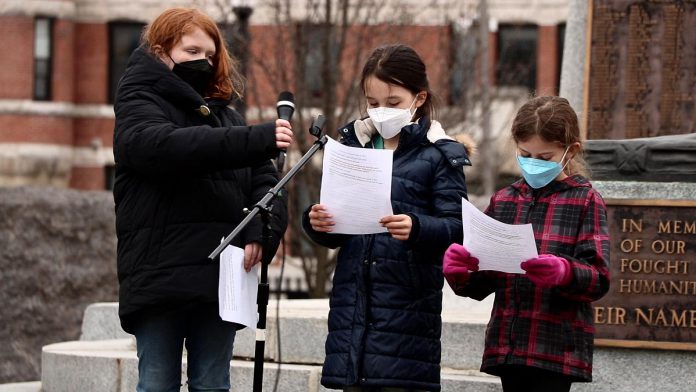 Three members of the Youth Climate Action Club of Peterborough-Nogojiwanong speaking during the Global Climate Strike event at Confederation Square in downtown Peterborough on March 25, 2022. (Photo: Sean Bruce)