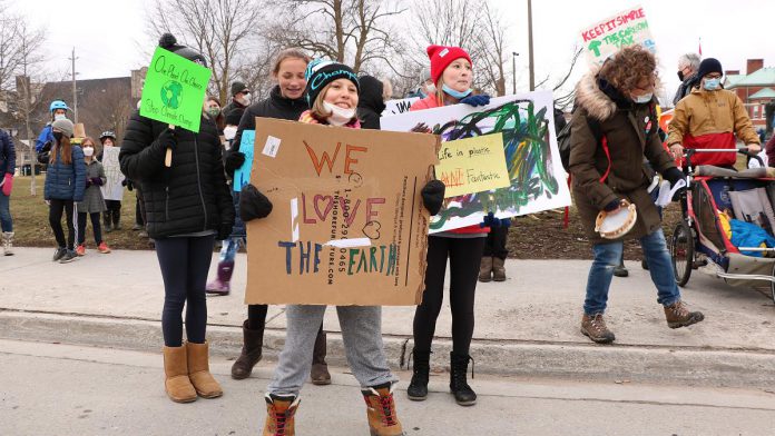 Participants holding signs during the Global Climate Strike event at Confederation Square in downtown Peterborough on March 25, 2022. (Photo: Sean Bruce)