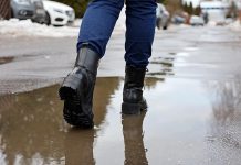 A pair of boots in melting snow. (Stock photo)