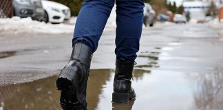 A pair of boots in melting snow. (Stock photo)