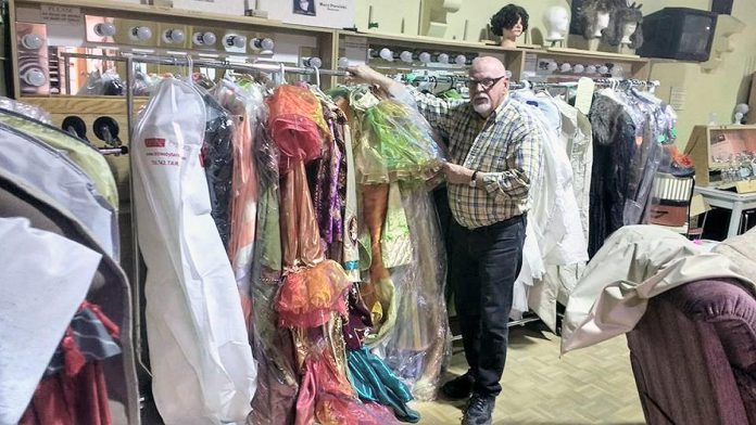 Howard Berry pictured in 2017 with some of the many costumes he designed for the Peterborough Theatre Guild over the years. (Photo: Sam Tweedle / kawarthaNOW)