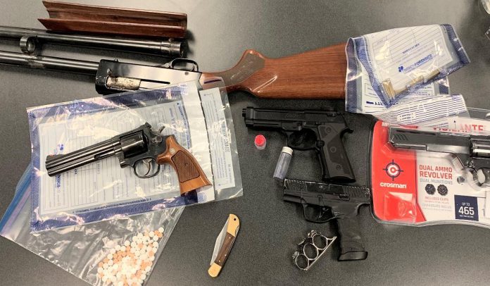 Kawartha Lakes police seized these weapons and drugs afte executing a search warrant at a residence on St. Paul Street in Lindsay on March 24, 2022. (Police-supplied photo)