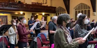 Some of the members of the Peterborough Singers singing the national anthem of Ukraine during a choir rehearsal on March 8, 2022. (kawarthaNOW screenshot of YouTube video)
