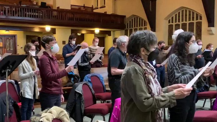 Some of the members of the Peterborough Singers singing the national anthem of Ukraine during a choir rehearsal on March 8, 2022. (kawarthaNOW screenshot of YouTube video)