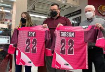 Peterborough Petes general manager Michael Oke (middle) presents Pink in the Rink honorary co-chairs Meaghan Roy and Doug Gibson with their jerseys. The 13th annual fundraising games, which aims to raise $50,000 the Canadian Cancer Society, takes place on April 9, 2022 when the Petes face off against the Niagara IceDogs. (Photo: Peterborough Petes)