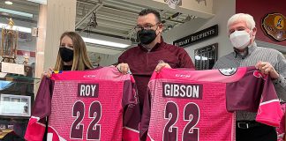 Peterborough Petes general manager Michael Oke (middle) presents Pink in the Rink honorary co-chairs Meaghan Roy and Doug Gibson with their jerseys. The 13th annual fundraising games, which aims to raise $50,000 the Canadian Cancer Society, takes place on April 9, 2022 when the Petes face off against the Niagara IceDogs. (Photo: Peterborough Petes)