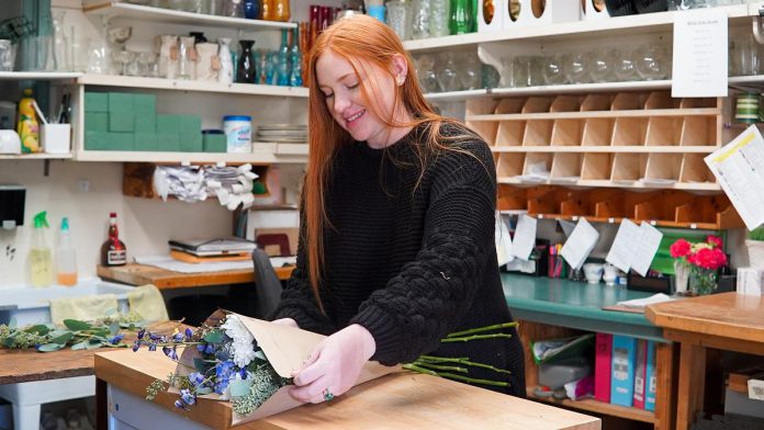 Female entrepreneurs who participate in Claire Bouvier's free two-part virtual workshop on March 24 and 31, 2022 will also receive follow-up support and resources from the Peterborough & the Kawarthas Economic Development Business Advisory Centre. Pictured is florist Rebecca Collinson at Lakefield Flowers & Gifts in the Village of Lakefield, a business owned by Robyn Jenkins. (Photo courtesy of PKED)