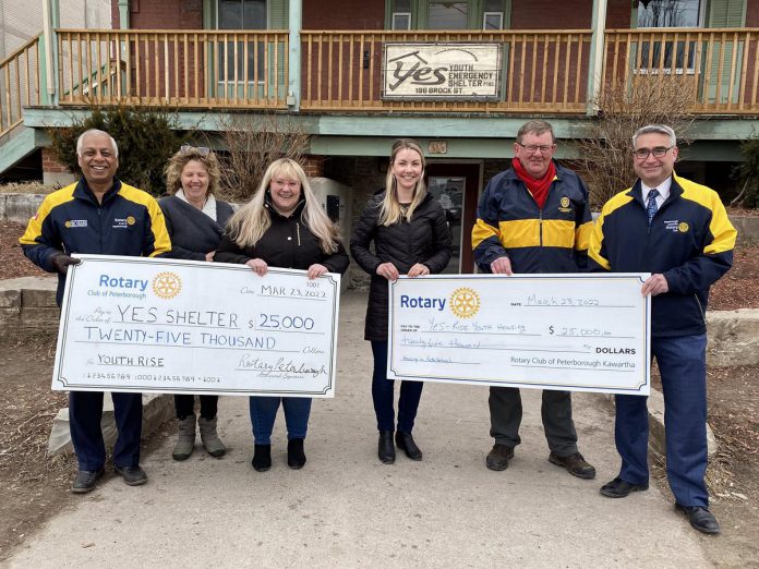 Atul Swarup and Marie Press of the Rotary Club of Peterborough presenting a $25,000 cheque to YES executive director Aimee Le Lagadéc (third from left) and Brian O'Toole and Carl Brown of the Rotary Club of Peterborough Kawartha present a $25,000 cheque to YES transitional housing manager Melissa Free (third from right) in front of YES's Brock Street location. (Photo: Rotary Club of Peterborough)