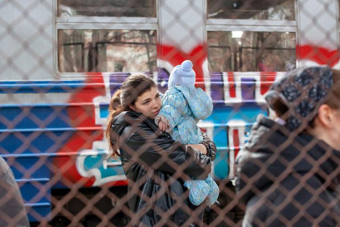 A Ukrainian family in Przemysl, Poland on February 27, 2022 after fleeing Russian aggression in Ukraine. (Photo: Mirek Pruchnicki)