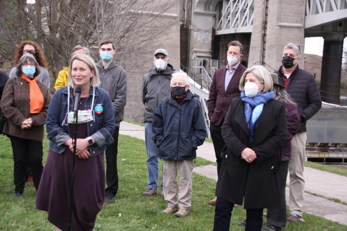 Jen Deck, the NDP candidate for Peterborough-Kawartha in the provincial election, at the microphone as Ontario NDP leader Andrea Horwath looks on during a media conference at the Peterborough Lift Lock on April 26, 2022. (Photo: Jeannine Taylor / kawarthaNOW)