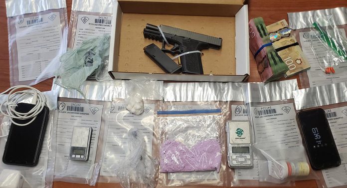 A loaded handgun, ammunition, fentanyl, crack cocaine, hydromorphone, scales, cell phones. and Canadian currency seized by police at a Peterborough residents on April 7, 2022 as part of a drug investigation by the OPP's Peterborough/Northumberland Community Street Crime Unit. (OPP-supplied photo)