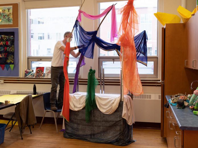 At a launch event on April 14, 2022, artist Brian Nichols works on a puppet theatre stage at the decommissioned King George Public School in Peterborough's East City,  the site of Public Energy Performing Arts' 'Erring at King George' multidisciplinary arts festival running from May 6 to 8 and 13 to 15. (Photo: Andy Carroll)