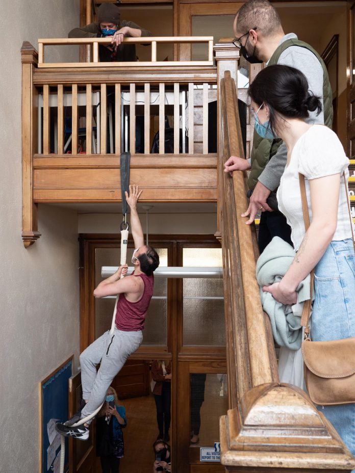 At a launch event on April 14, 2022, Thomas Vaccaro of the Peterborough Academy of Circus Arts performs "No Elevator to Success" in a stairwell of Peterborough's decommissioned King George Public School, the site of Public Energy Performing Arts' 'Erring at King George' multidisciplinary arts festival running from May 6 to 8 and 13 to 15. (Photo: Andy Carroll)