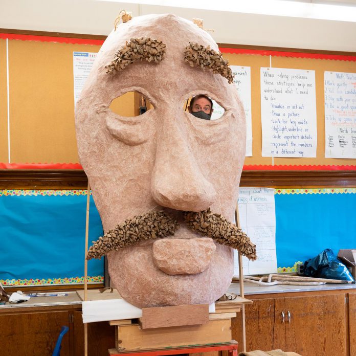 Artist Brad Brackenridge peers through the eye socket of his giant Edward Lear puppet head on April 14, 2022 at the decommissioned King George Public School in Peterborough's East City during a launch event for Public Energy Performing Arts' 'Erring at King George' multidisciplinary arts festival, which runs from May 6 to 8 and 13 to 15. (Photo: Andy Carroll)