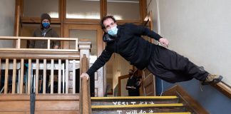 At a launch event on April 14, 2022, Wes Ryan of the Peterborough Academy of Circus Arts performs "No Elevator to Success" in a stairwell of Peterborough's decommissioned King George Public School, the site of Public Energy Performing Arts' 'Erring at King George' multidisciplinary arts festival running from May 6 to 8 and 13 to 15. (Photo: Andy Carroll)