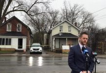 Detective sergeant Josh McGrath of the major crimes unit of the Peterborough Police Service speaks at a media briefing on April 21, 2022 across the street from a home at 124 Park Street South, where two Mississauga were shot the previous afternoon, with one later dying in hospital from his injuries. (kawarthaNOW screenshot of Peterborough Police Service video)