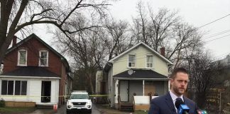 Detective sergeant Josh McGrath of the major crimes unit of the Peterborough Police Service speaks at a media briefing on April 21, 2022 across the street from a home at 124 Park Street South, where two Mississauga were shot the previous afternoon, with one later dying in hospital from his injuries. (kawarthaNOW screenshot of Peterborough Police Service video)